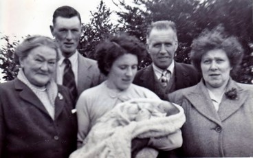 Paternal granny, Dad, Mum holding me, maternal grandad and granny. Family History